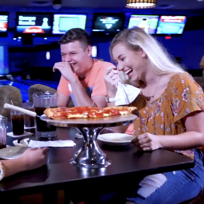 Pizza party setup at an indoor entertainment venue